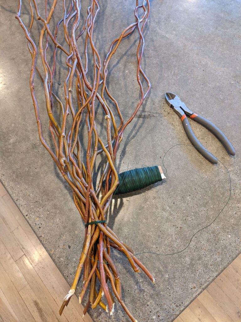 Wrapping a bunch of curly willow branches with floral wire to make a wreath.